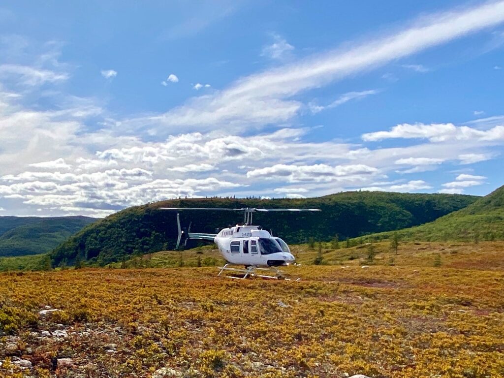 Breton Air Helicoptor awaiting take-off from a field in the Cape Breton Highlands